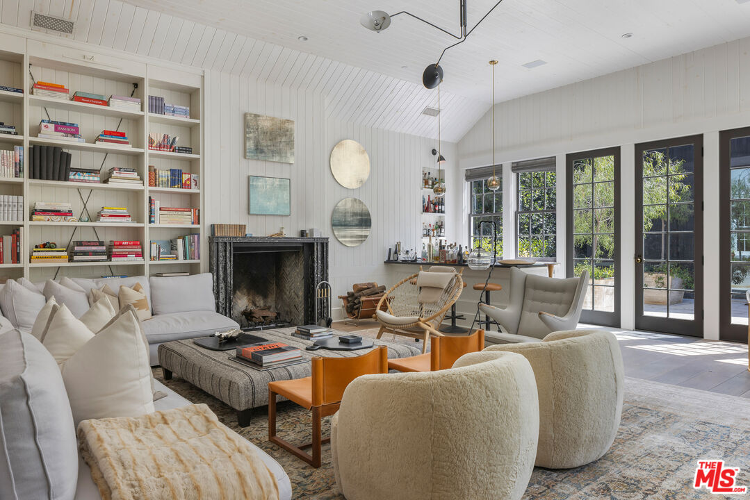 1701 Westridge Road Los Angeles, CA 90049 - Photo 17 of 36 a living room with fireplace furniture and a large window