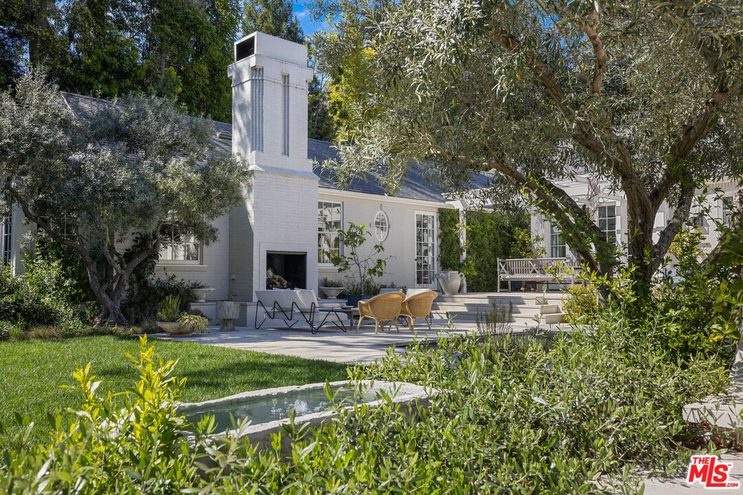 1701 Westridge Road Los Angeles, CA 90049 - Photo 19 of 36 a view of a house with backyard and sitting area