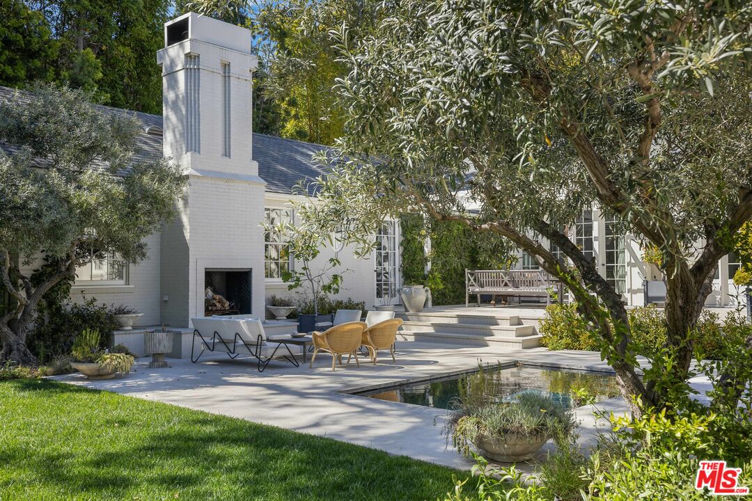 1701 Westridge Road Los Angeles, CA 90049 - Photo 20 of 36 a front view of a house with garden and trees
