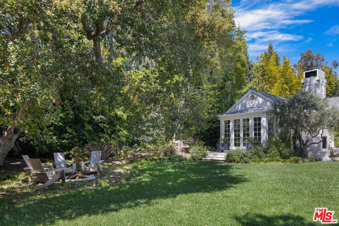 1701 Westridge Road Los Angeles, CA 90049 - Photo 21 of 36 a view of a house with a yard and sitting area