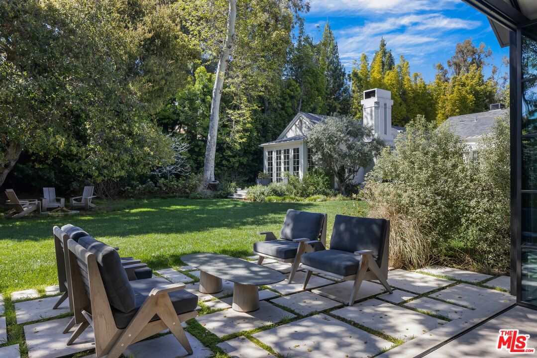 1701 Westridge Road Los Angeles, CA 90049 - Photo 24 of 36 a view of a chairs and table in backyard of the house
