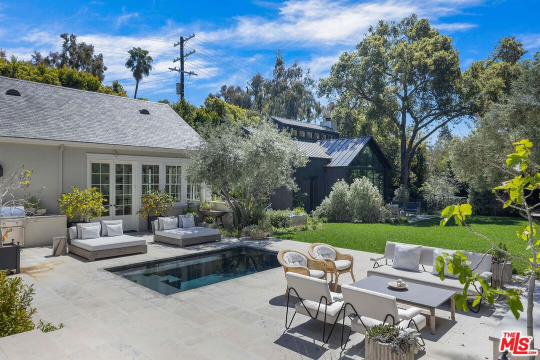 1701 Westridge Road Los Angeles, CA 90049 - Photo 25 of 36 a view of a patio with couches table and chairs with garden and plants