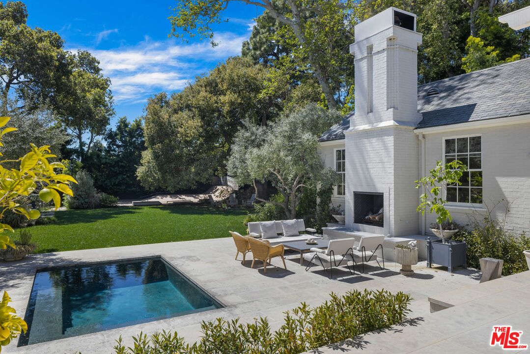 1701 Westridge Road Los Angeles, CA 90049 - Photo 26 of 36 a view of a house with backyard and sitting area