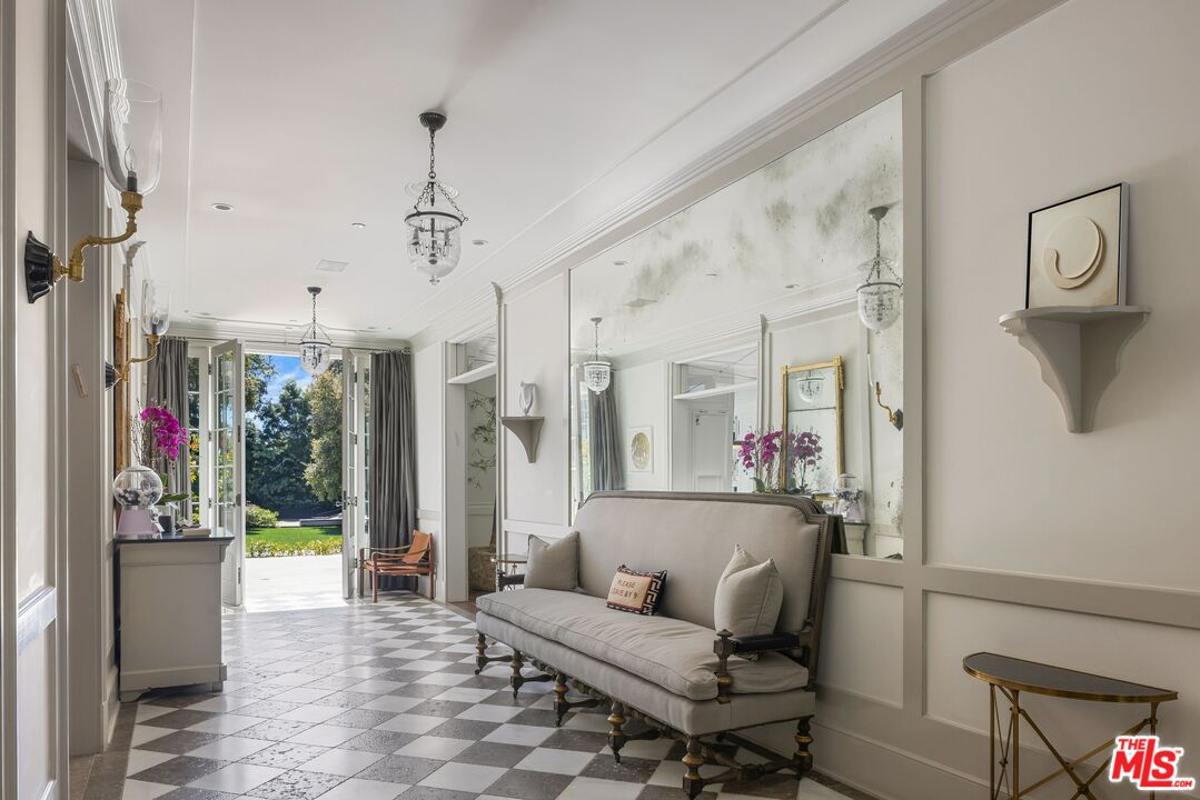 1701 Westridge Road Los Angeles, CA 90049 - Photo 4 of 36 a living room with furniture and a chandelier