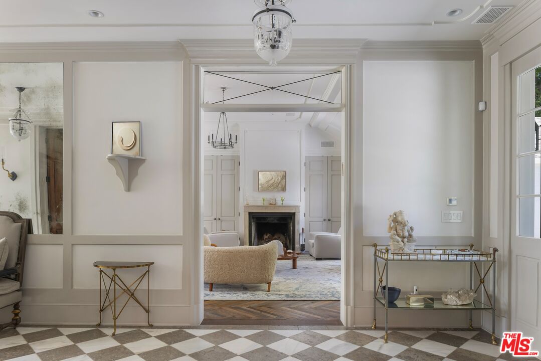 1701 Westridge Road Los Angeles, CA 90049 - Photo 5 of 36 a living room with furniture and a fireplace