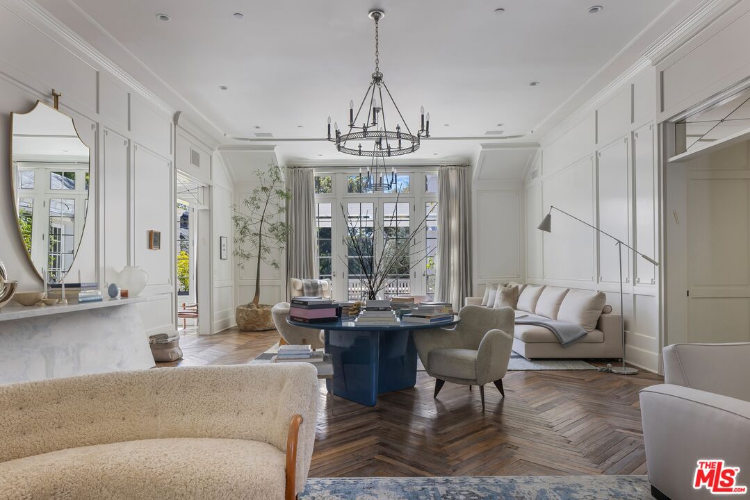 1701 Westridge Road Los Angeles, CA 90049 - Photo 7 of 36 a living room with fireplace furniture and a chandelier
