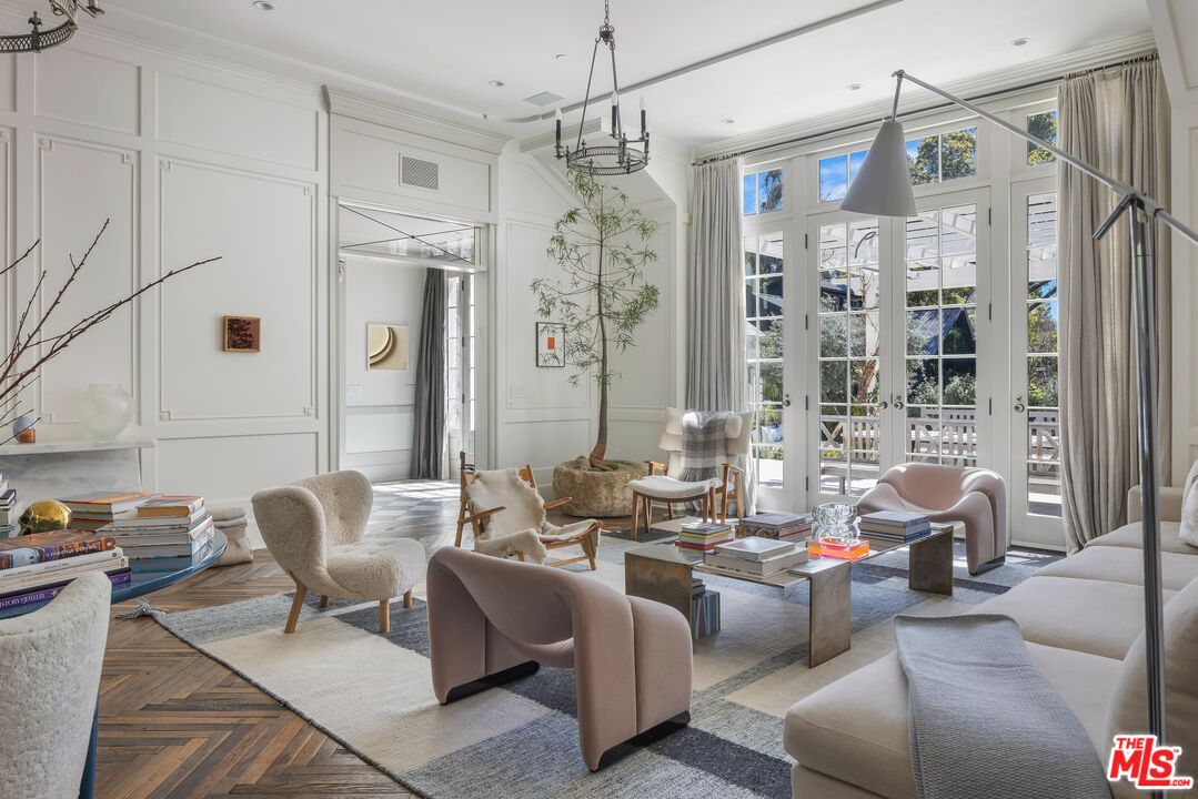 1701 Westridge Road Los Angeles, CA 90049 - Photo 8 of 36 a living room with patio furniture and a chandelier