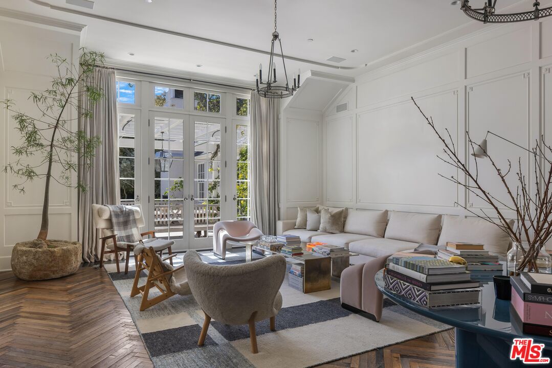 1701 Westridge Road Los Angeles, CA 90049 - Photo 9 of 36 a living room with furniture and a chandelier