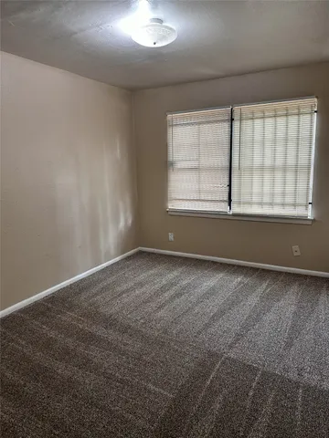 an empty room with a empty space and windows