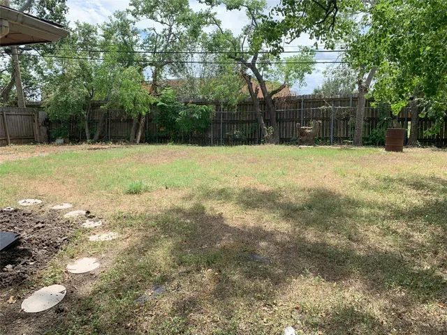 a backyard of a house with lots of green space
