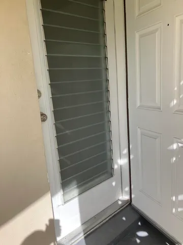 a kitchen with granite countertop white cabinets and black appliances