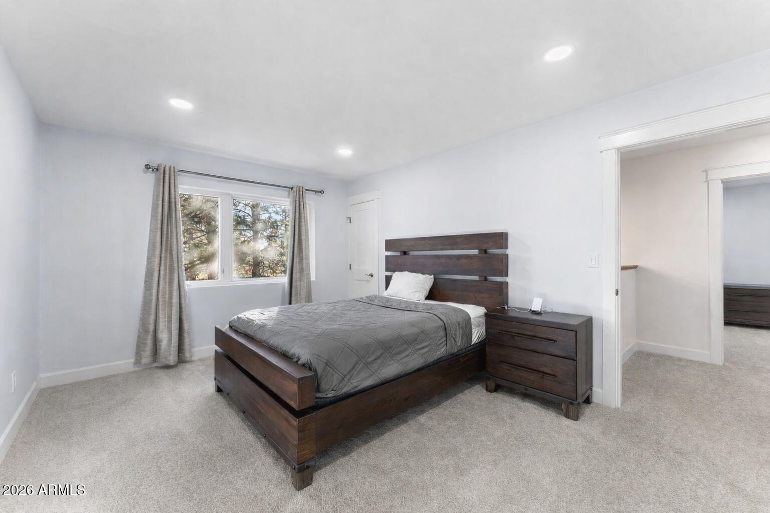 5055 Townsend-Winona Road Flagstaff, AZ 86004 - Photo 22 of 34 a spacious bedroom with a bed and window