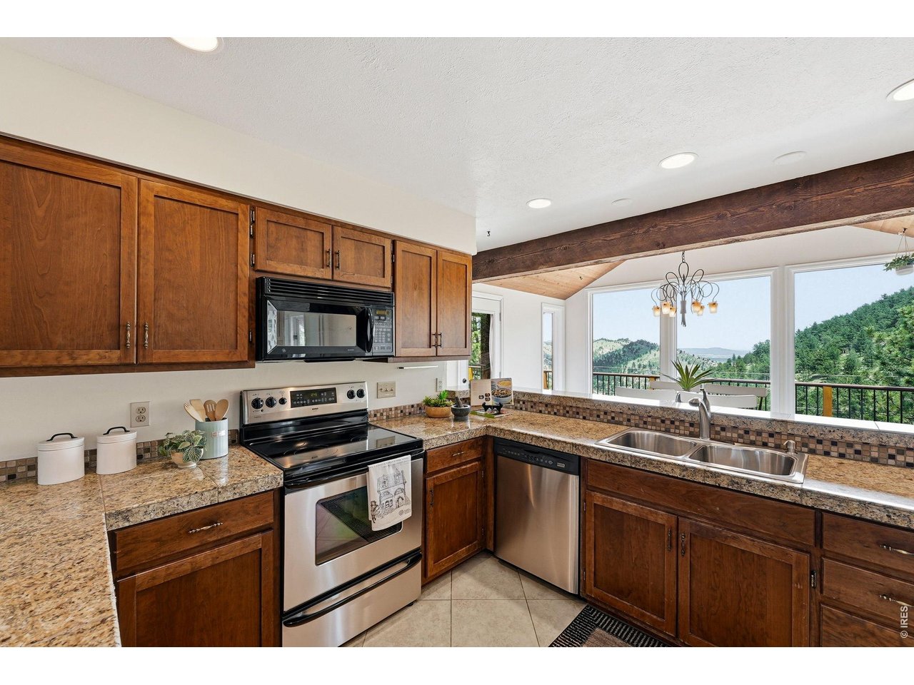 607 North Cedar Brook Road Boulder, CO 80304 - Photo 4 of 36 Kitchen opens to the dining area with a wall of windows