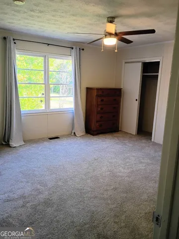 a view of livingroom with hardwood floor and ceiling fan
