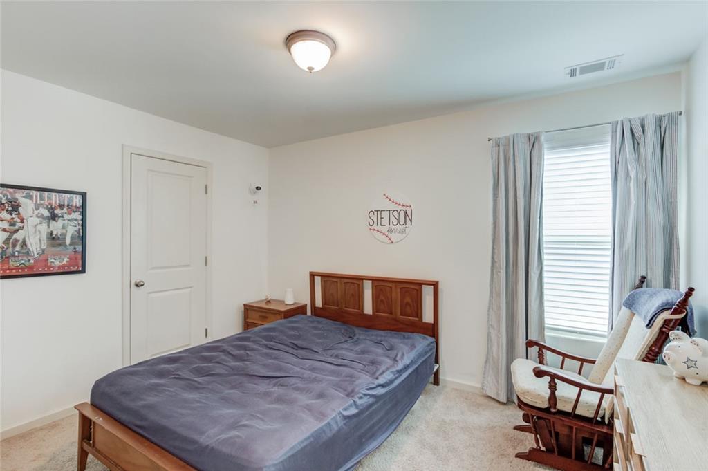 331 Merigold Way Pendergrass, GA 30567 - Photo 23 of 39 a bedroom with a bed and a window