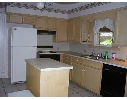 a kitchen with a sink a stove and refrigerator