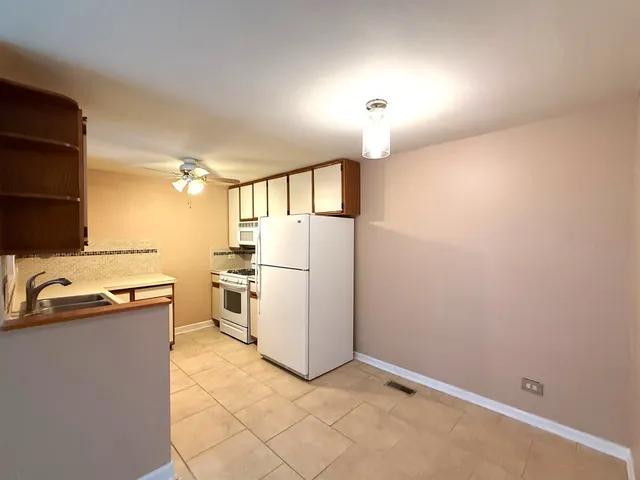 a kitchen with a refrigerator and a sink