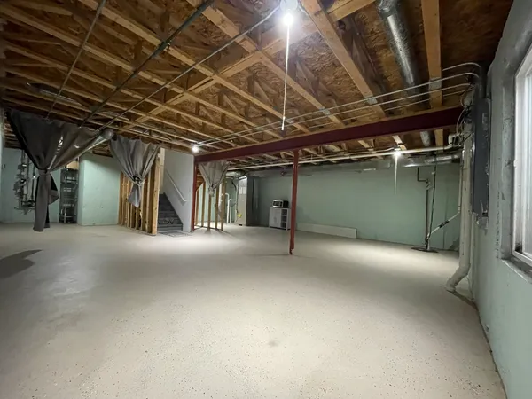 a view of empty room with refrigerator
