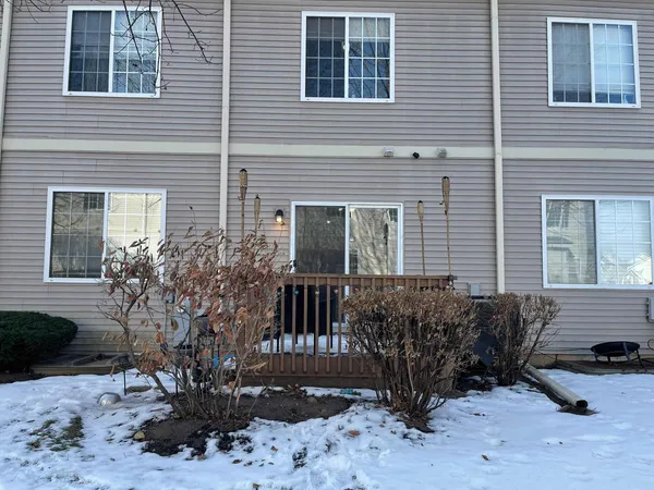 a view of a house with a yard and sitting area
