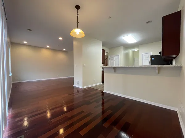 a view of a room with wooden floor and a window