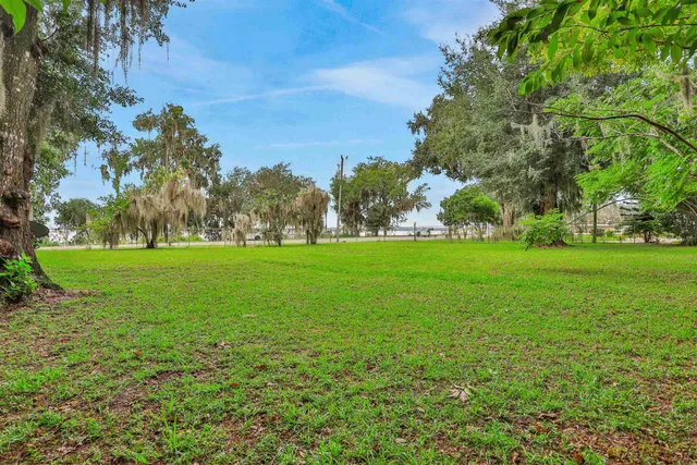a view of field with trees in the background