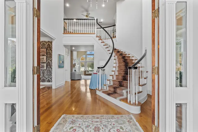 a view of an entryway with wooden floor and a livingroom view
