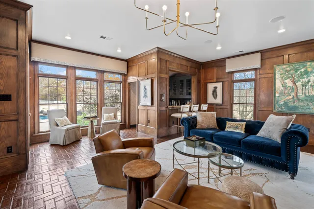 a living room with furniture ceiling fan and a rug