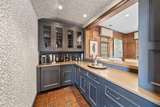 a kitchen with sink and large window