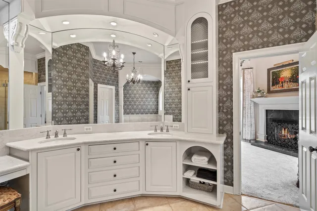 a en suite bathroom with a sink double vanity and a mirror