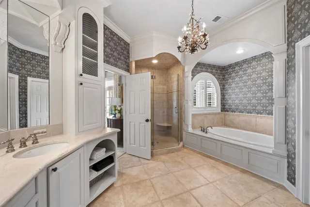 a spacious bathroom with a sink a large mirror and a bathtub with shower