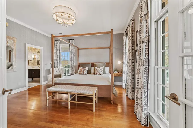 a dining room with wooden floor a glass table and chairs