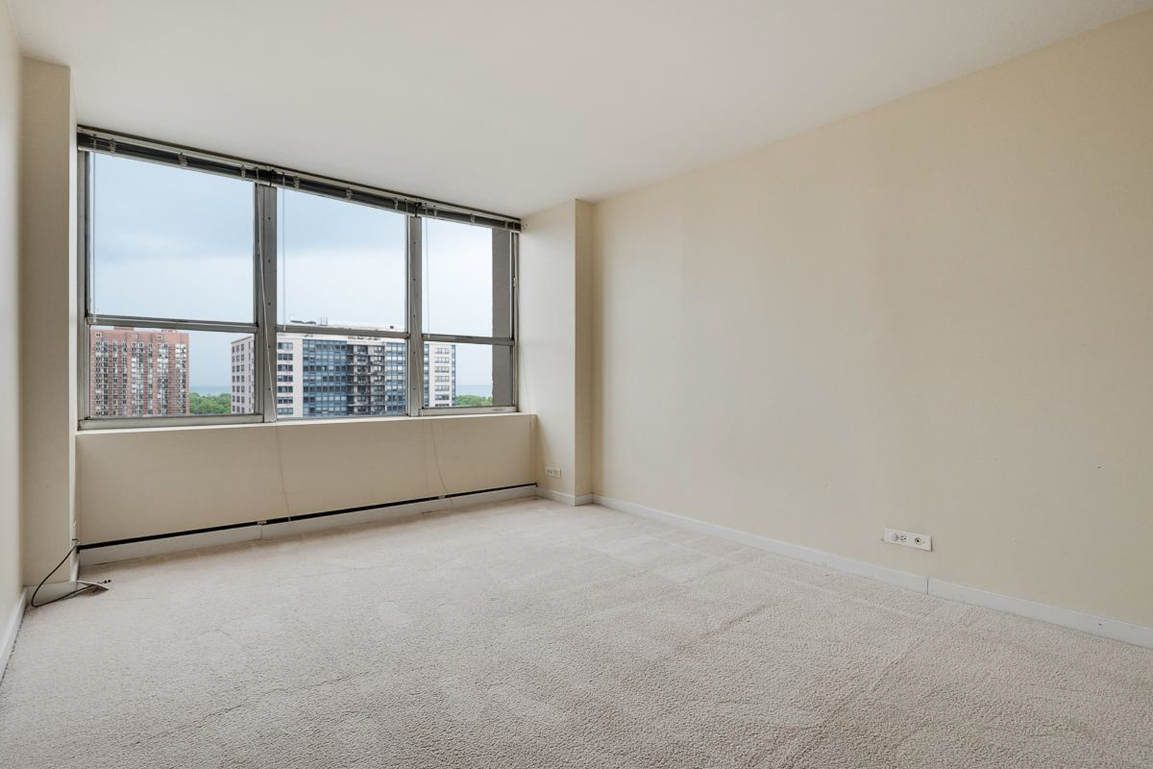 655 West Irving Park Road, Unit 1502 Chicago, IL 60613 - Photo 6 of 24 a view of an empty room with a window