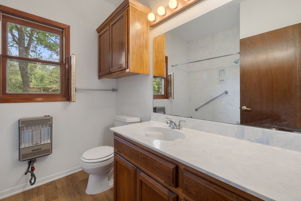 244 Woodway Elgin, TX 78621 - Photo 28 of 40 a bathroom with a sink a toilet and mirror