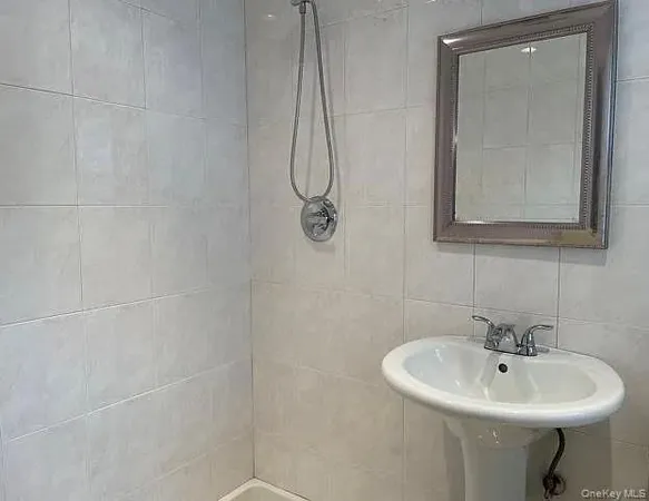 a bathroom with a sink a mirror and shower