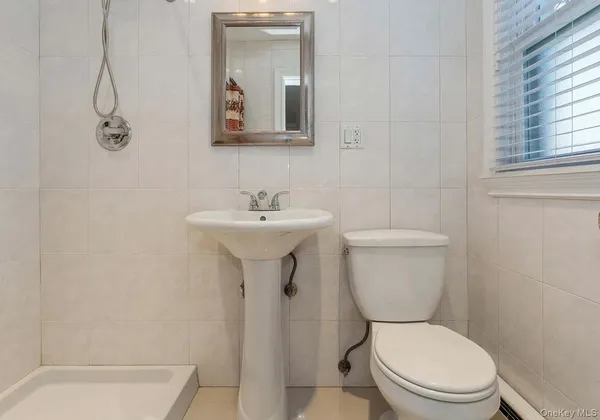 a white toilet sitting next to a bathroom sink