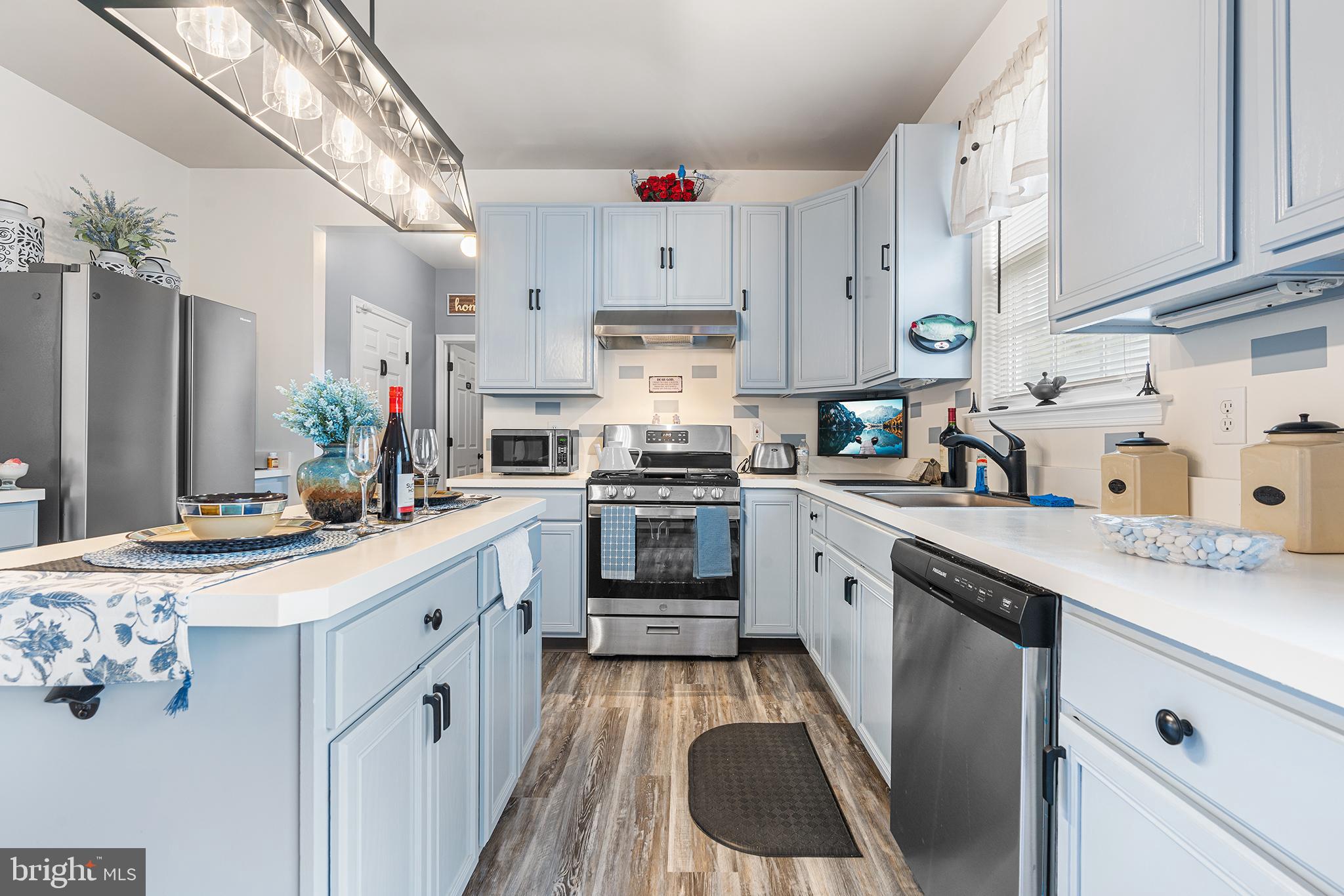 19 Howard Street Carneys Point, NJ 08069 - Photo 15 of 39 a kitchen with kitchen island granite countertop a sink stove and cabinets