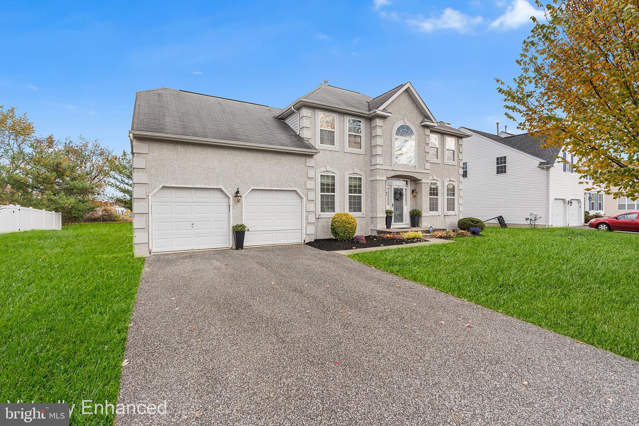 19 Howard Street Carneys Point, NJ 08069 - Photo 2 of 39 a front view of a house with a yard and garage