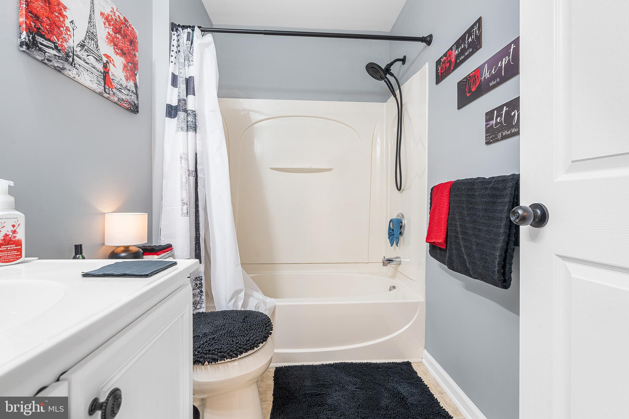 19 Howard Street Carneys Point, NJ 08069 - Photo 33 of 39 a bathroom with a sink a bath tub and a shower curtain