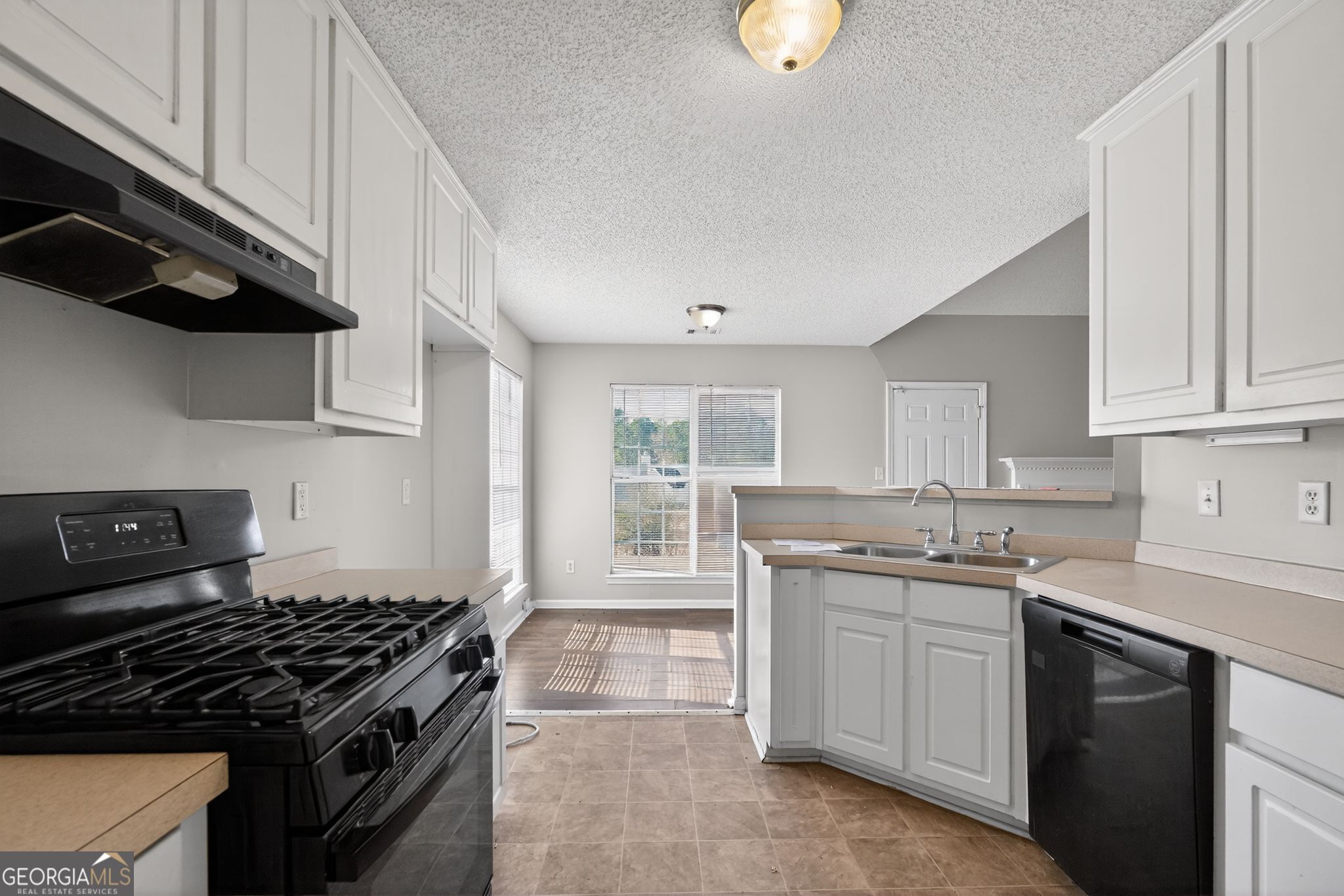 4708 Golod Way Lithonia, GA 30038 - Photo 15 of 33 a kitchen with white cabinets and appliances