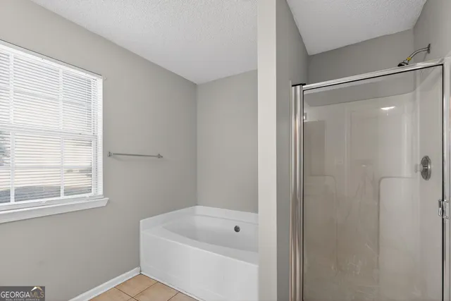 a bathroom with a shower a window and a shower