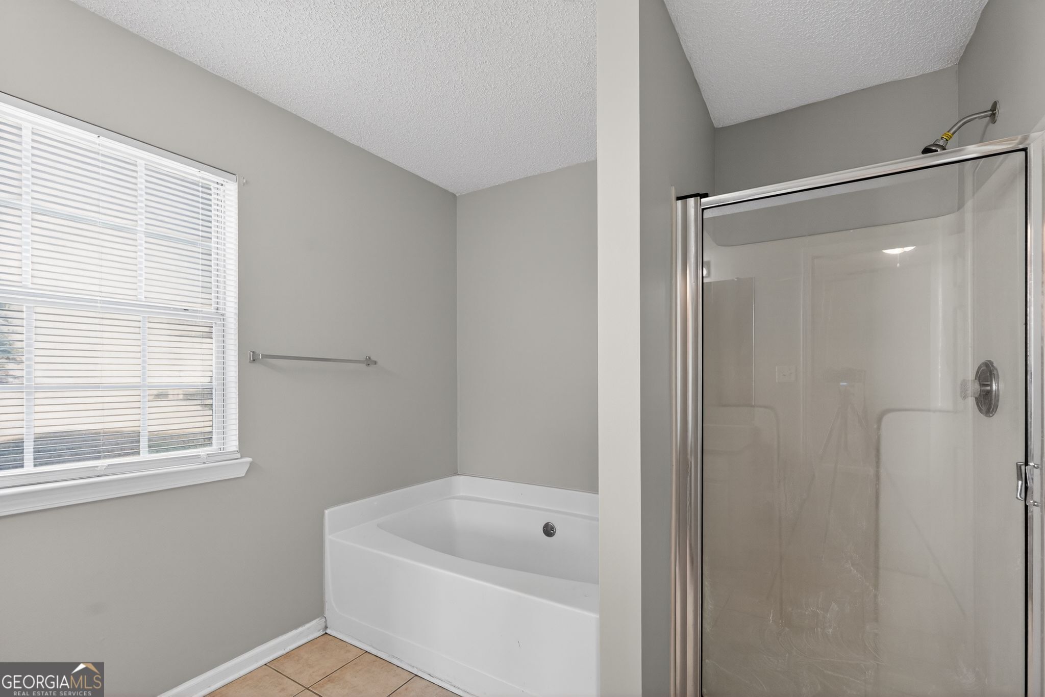4708 Golod Way Lithonia, GA 30038 - Photo 23 of 33 a bathroom with a shower a window and a shower