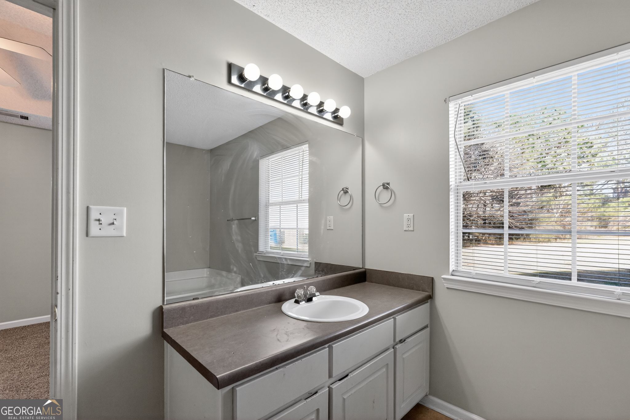 4708 Golod Way Lithonia, GA 30038 - Photo 25 of 33 a bathroom with a sink and a mirror