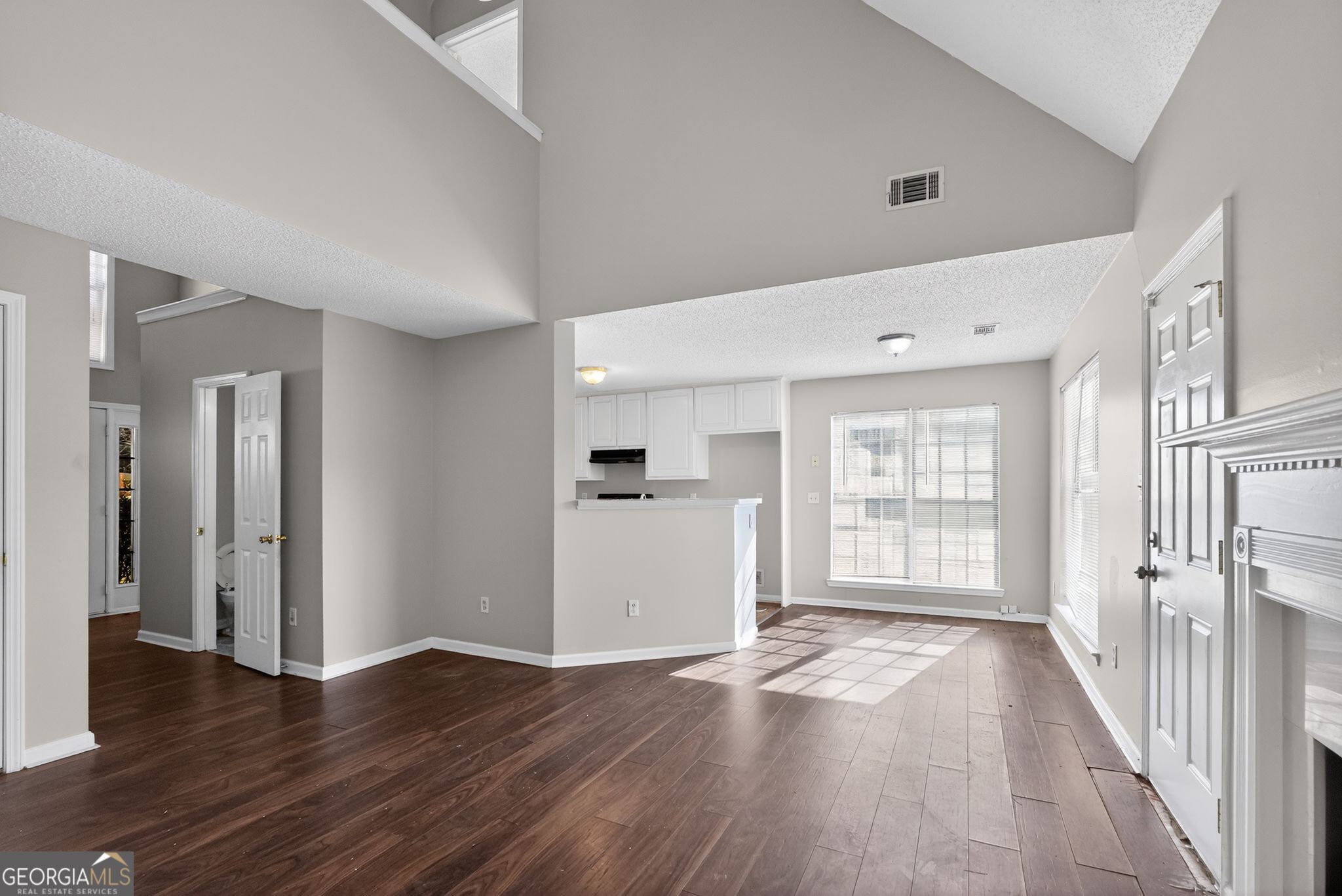 4708 Golod Way Lithonia, GA 30038 - Photo 8 of 33 an empty room with wooden floor and windows