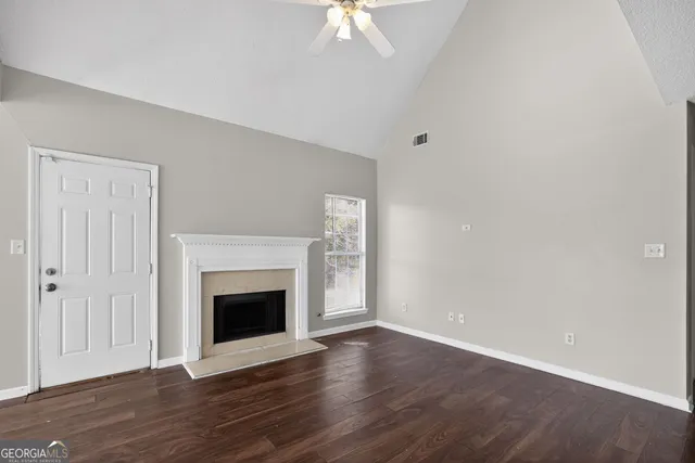 wooden floor fireplace and natural light in room