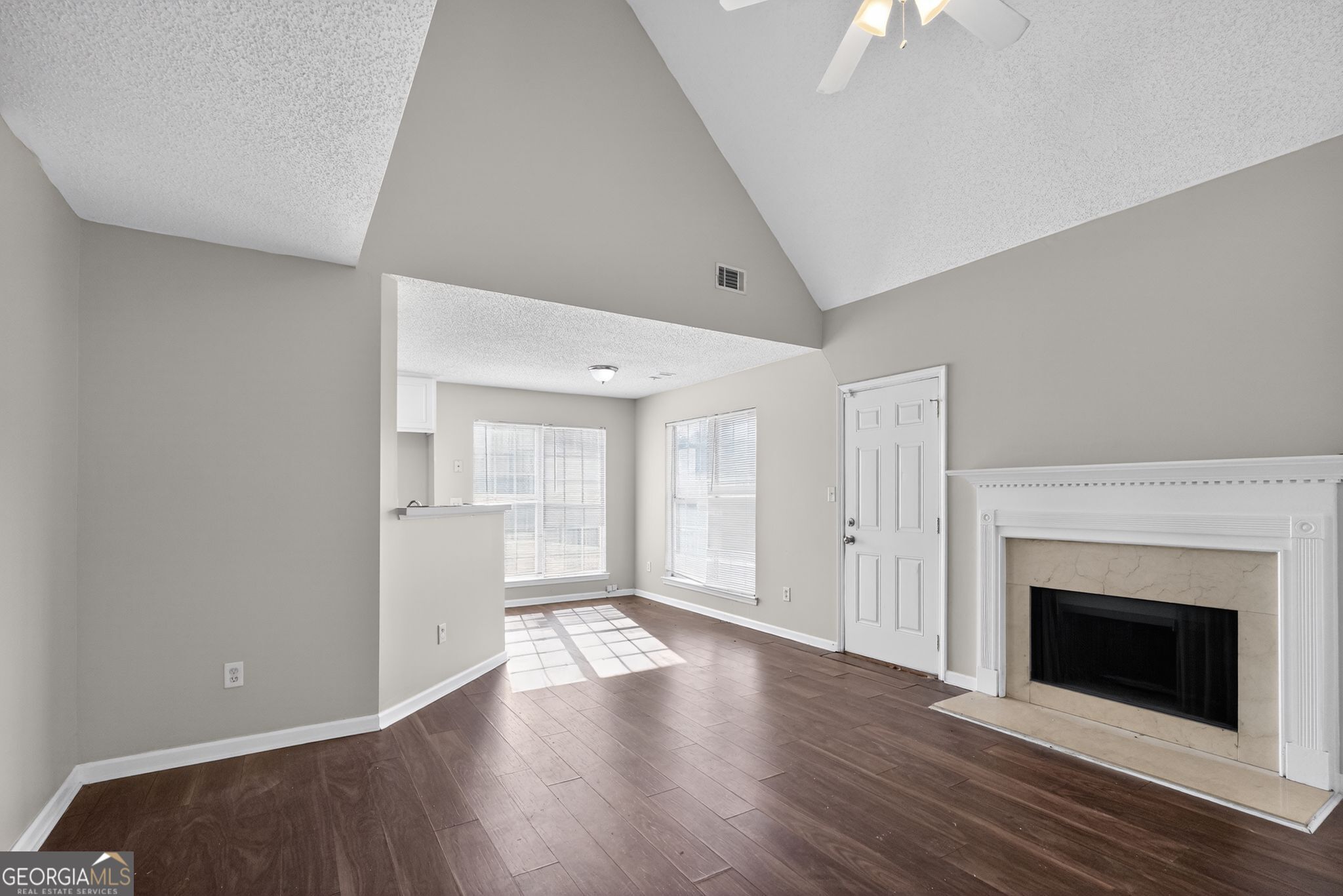 4708 Golod Way Lithonia, GA 30038 - Photo 10 of 33 a view of an empty room with wooden floor fireplace and a window