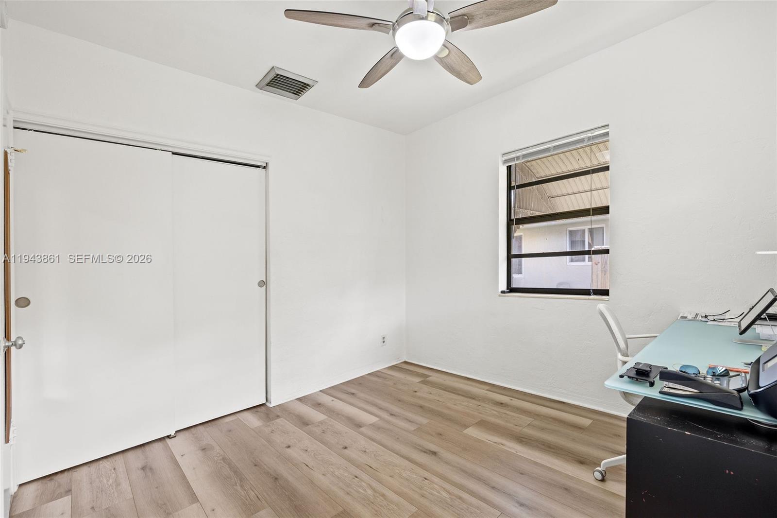 206 Southeast 5th Street Dania Beach, FL 33004 - Photo 15 of 26 a view of a room with wooden floor and ceiling fan