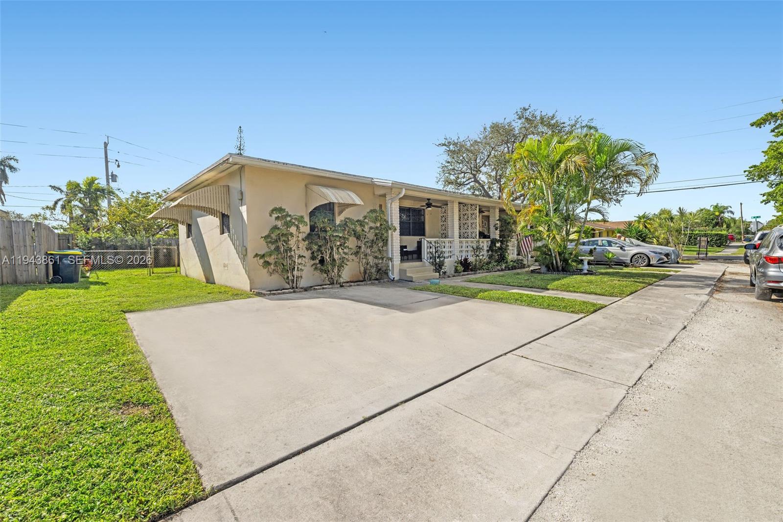 206 Southeast 5th Street Dania Beach, FL 33004 - Photo 2 of 26 a front view of a house with a yard and trees