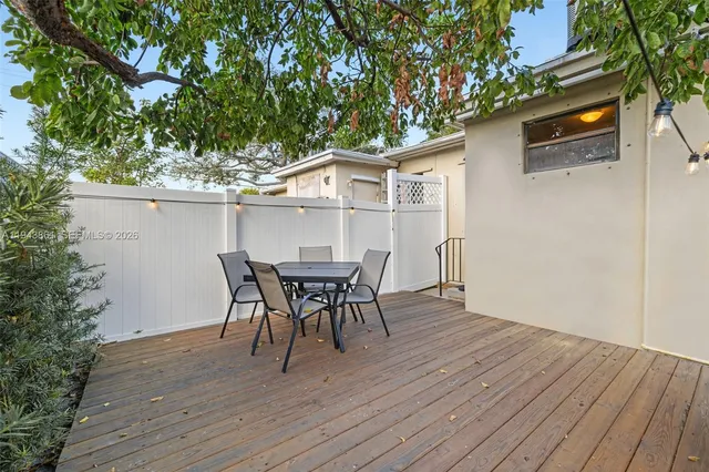 a view of a house with a patio table and chairs