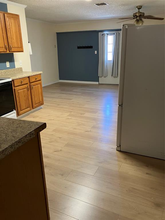 717 Bluebonnet Street Mexia, TX 76667 - Photo 12 of 25 a view of a livingroom with wooden floor and staircase