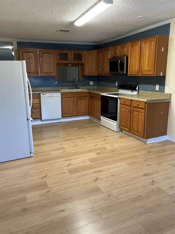 717 Bluebonnet Street Mexia, TX 76667 - Photo 15 of 25 a kitchen with stainless steel appliances granite countertop a stove microwave and sink